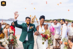 Confetti showers a couple exiting their outdoor ceremony in Olbia, Sardegna, Italy, captured by a WPJA photographer.